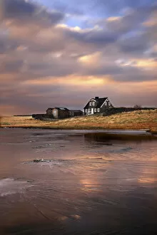 Icelandic Gallery: Sunset in Arnastapi, Iceland. Typical Icelandic Farm reflected in the frozen lake