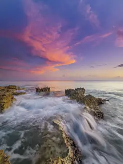 Motion Prints: Sunset on the Caribbean Sea along the rugged ironshore of Grand Cayman
