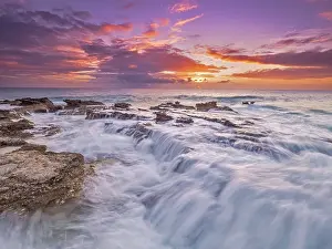 Motion Prints: Sunset on the Caribbean Sea along the rugged ironshore of Grand Cayman