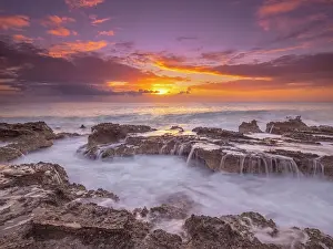 Cayman Prints: Sunset on the Caribbean Sea along the rugged ironshore of Grand Cayman