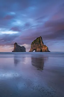 Sunset clouds above Archway Islands. Wharariki beach, Puponga, Tasman district, South Sunset clouds above Archway Islands. Wharariki beach, Puponga, Tasman district, South