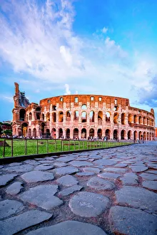 Latium Prints: Sunset over the Coliseum view from famous empty cobblestoned Via Sacra, Rome, Italy