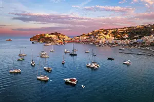 Tyrrhenian Prints: Sunset above the colorful fishing village of Ponza with boats anchored in the bay