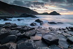 Sunset over the Giant's Causeway World Heritage Site on the Causeway Coast, Bushmills, County Antrim, Northern Ireland. Autumn (November) 2022