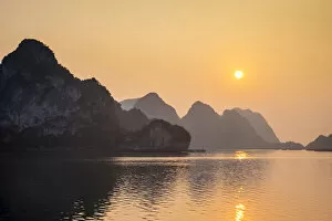Sunset over karst mountains in Ha Long Bay, QuaA┬║£ng Ninh Province, Vietnam