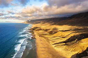 Sunlight Prints: Sunset over mountains and golden sand of Cofete Beach washed by the ocean, Jandia