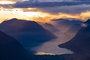 Images Dated 12th December 2017: Sunset over the mountains and the lake Lugano, Switzerland