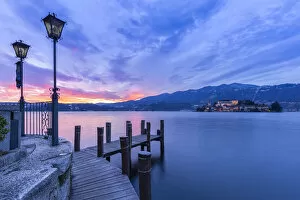 Monastery Gallery: Sunset near a pier in front of San Giulio island and Lake Orta