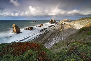 Tide Prints: Sunset with rainbow at Playa de la Arnia, Boo de Pielagos, Cantabria, Spain