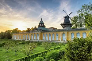 Sanssouci Prints: Sunset at the rococo palace Neue Kammern with the windmill in the Sanssouci park