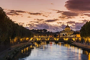 Sunset view of Tiber river with St. Peters Basilica in the background, Rome