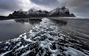 Stokksnes Prints: Surf from waves on black volcanic sand beach with Vestrahorn in the distance