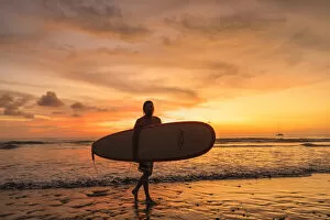 Activity Gallery: Surfer at Playa de Jaco at sunset, Jaco, Pacific coast, Puntarenas, Costa Rica