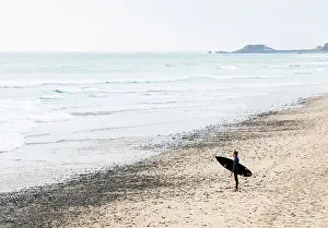 Water Sport Prints: A surfer on the St Ouens Bay beach, Jersey, Channel Islands