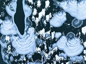 Frozen Water Prints: Surreal ice shapes on frozen surface of lake Montespluga