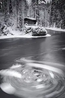 Waters Edge Prints: Surreal vortex of icy water surrounding the snowy landscape near Myllykoski old mill