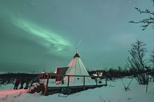 Abisko Gallery: Swedish Lapland, Abisko National Park. Northern Lights over a typical teepee in the snow, winter