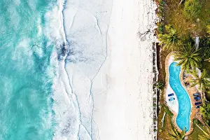 Tropical Climate Prints: Swimming pool of a tourist resort on white coral beach washed by waves