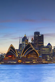 Sydney Opera House and skyline at sunset, Sydney, New South Wales, Australia