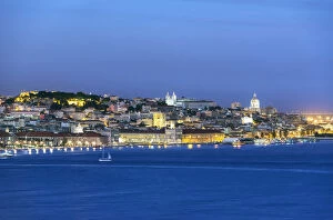The Tagus river (Tejo river) and the historic centre of Lisbon at twilight. Portugal