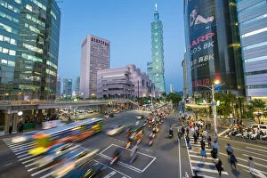 Taiwan, Taipei, traffic in front of Taipei 101 at a busy downtown intersection in