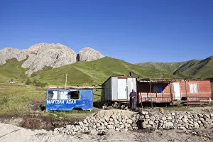 Tajikistan Prints: A Tajik woman stands outside her home on the Pamir Highway; Tajikistan