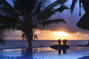 Tanzania. Zanzibar, Kigomani, Couple relaxing inside infinity pool overlooking the
