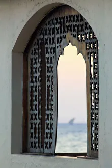 Historic Town Prints: Tanzania. Zanzibar, Stone Town, Old Town, Dhow (traditional sailboat) sailing at sunset