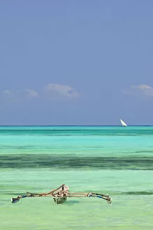 Images Dated 7th March 2012: Tanzania, Zanzibar, Unguja, Jambiani. A traditional dhow moored near the shore