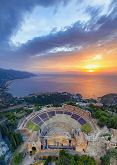 Archaeology Gallery: Taormina, Sicily. Aerial view of the Greek theater with the sun rising on the sea in the