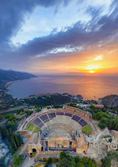 Ancient Monument Prints: Taormina, Sicily. Aerial view of the Greek theater with the sun rising on the sea in
