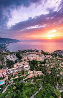 Taormina, Sicily. Aerial view of the Greek theater with the sun rising on the sea in