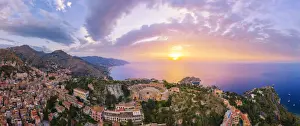 Taormina, Sicily. Aerial view of the Greek theater with the sun rising on the sea in