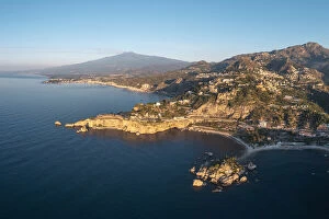 Taormina, Sicily, Italy. Coastal aerial landscape and Mount Etna in the backdrop