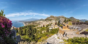 Taormina, Sicily, Italy. The Greek theatre, the cityscape and Mount Etna in the backdrop