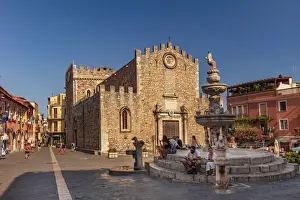Taormina, Sicily. people sitting on the fountain near the Cathedral