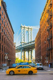 Images Dated 2nd February 2017: Taxi passing under the Manhattan bridge with the Empire state building framed in the