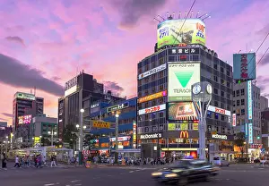 Traffic Prints: Taxi passing neon signs on side of buildings, Susukino, Sapporo, Hokkaido, Japan