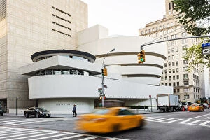 Taxis passing the Solomon R Guggenheim Museum, New York, USA