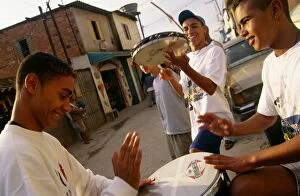 Images Dated 17th June 2009: Teenage boys drum and play the tambourine in their neighborhood in Sao Paulo