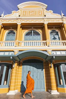 Thailand, Bangkok, Monk Walking Past Restored Traditional Shop Fronts