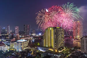 Thailand, Bangkok, Riverside Area, high angle skyline view with fireworks, dusk Thailand, Bangkok, Riverside Area, high angle skyline view with fireworks, dusk