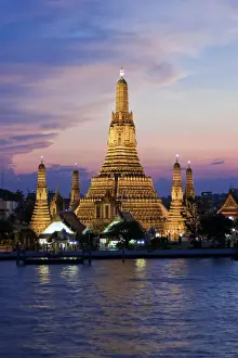 Thailand, Bangkok, Wat Arun, Temple Of The Dawn & Chao Phraya River illuminated at sunset