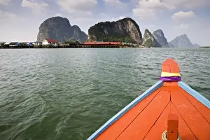 Stilt Village Prints: Thailand, Phang-Nga, Ko Panyi. The fishing village of Ko Panyi viewed from a long-tail boat