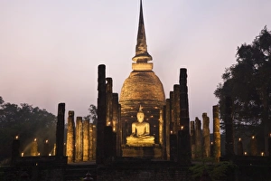 Thailand, Sukhothai, Sukhothai. Ruins of Wat Sa Si (also known as Sacred Pond Monastery) lit during the festival of Loy Krathong in the Sukhothai