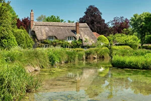 Images Dated 5th July 2023: Thatched Cottage Reflecting in Village Pond, Sherrington, Wiltshire, England
