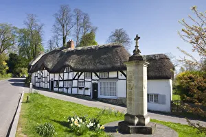 Thatched Cottages Prints: Thatched cottages and war memorial in the village of Wherwell, Hampshire, England