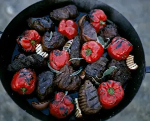 Eastern Cape Prints: Thick steaks and whole red peppers cooked on an open fire at Kwandwe Lodge