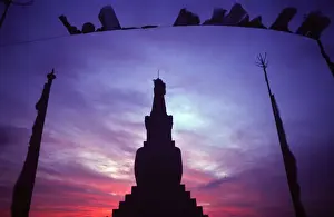 Mauve Prints: Tibetan Buddhist stupa and prayer flags silhouetted against sunset