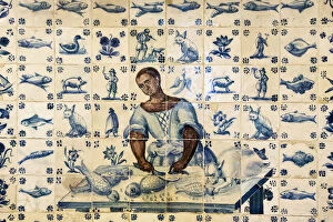 Tiles representing a black woman preparing fish